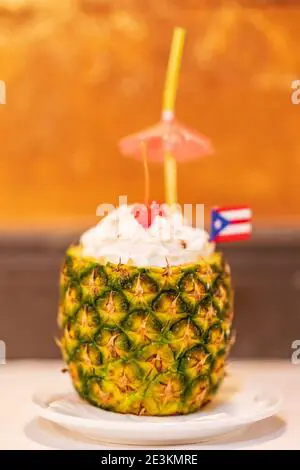 Delicious Piña Colada Cocktail Garnished with an Umbrella and Puerto Rican Flag Stock Photo - Alamy